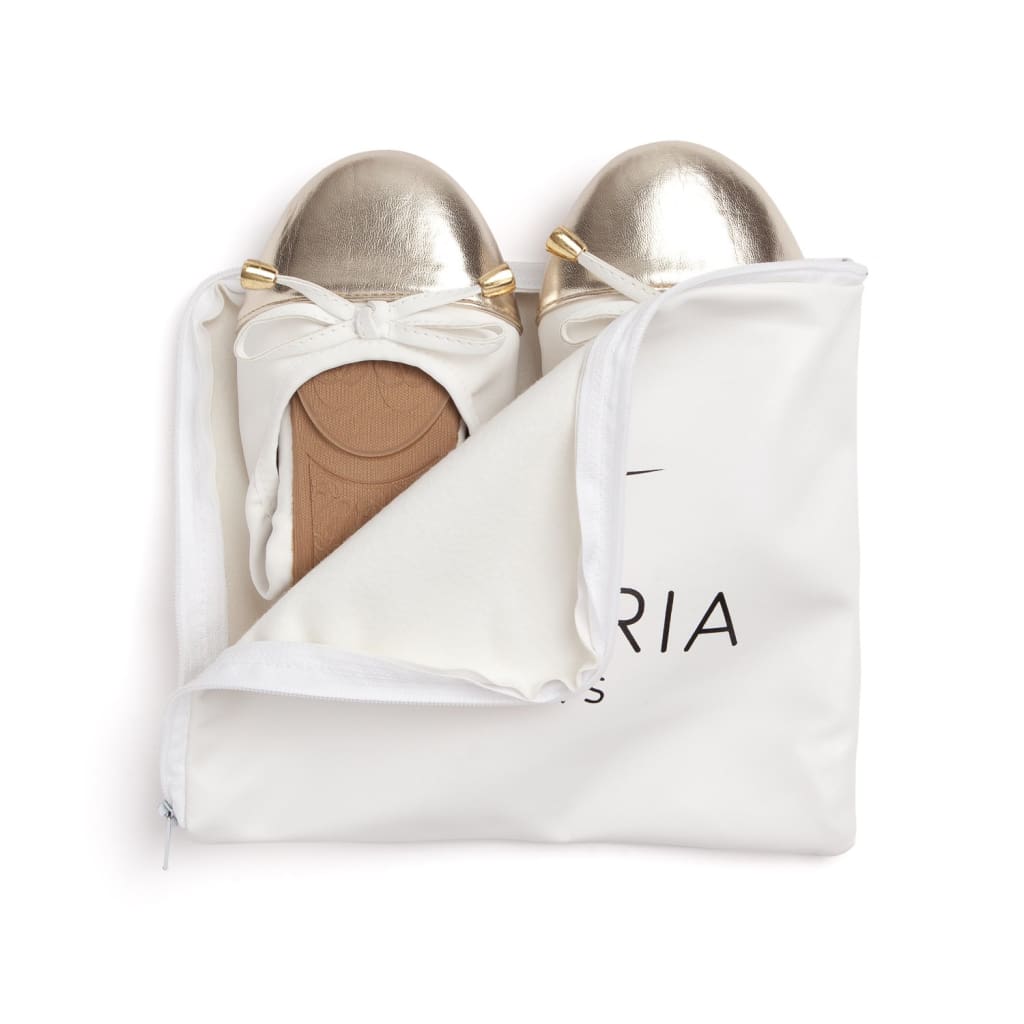 White flats in white storage pouch, metallic toe caps and bow tie laces