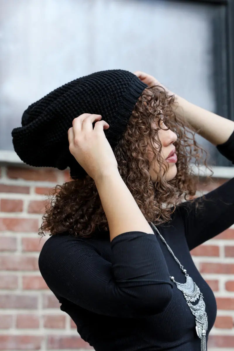 Black slouch waffle knit beanie shown from side, thick textured knit
