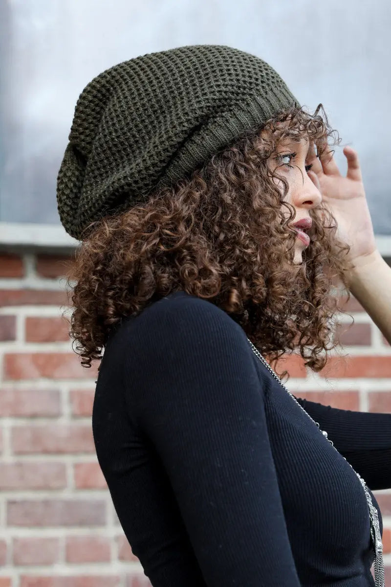 Olive slouch waffle knit beanie on head, textured weave and ribbed cuff
