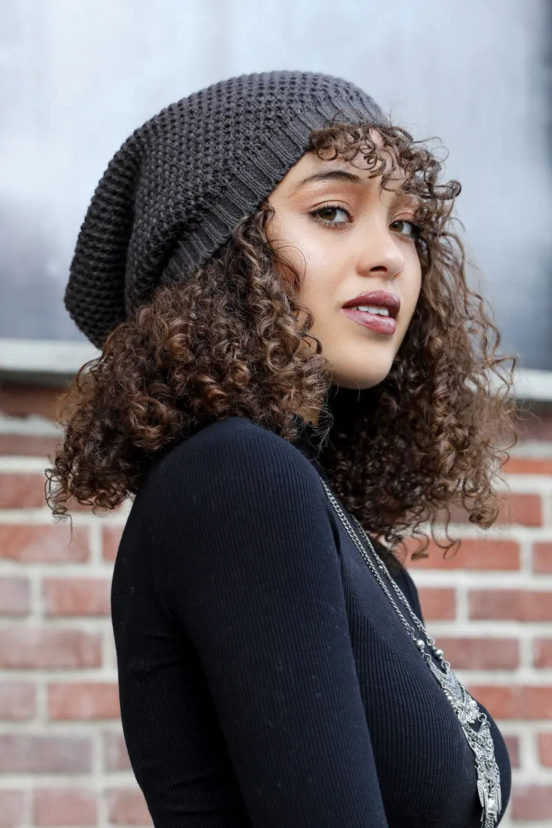 Slouch waffle knit beanie in dark gray, textured stitch cuff, worn in side profile