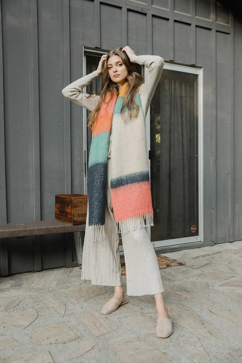 Striped mohair scarf with peach, teal, and blue tones, fringed ends.