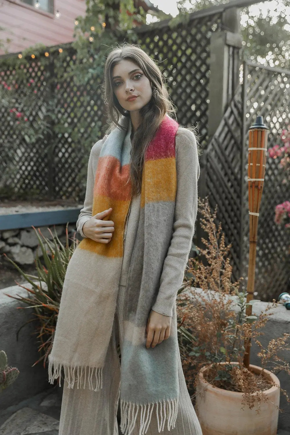 Striped mohair scarf in oatmeal, orange, and teal with long fringe ends.