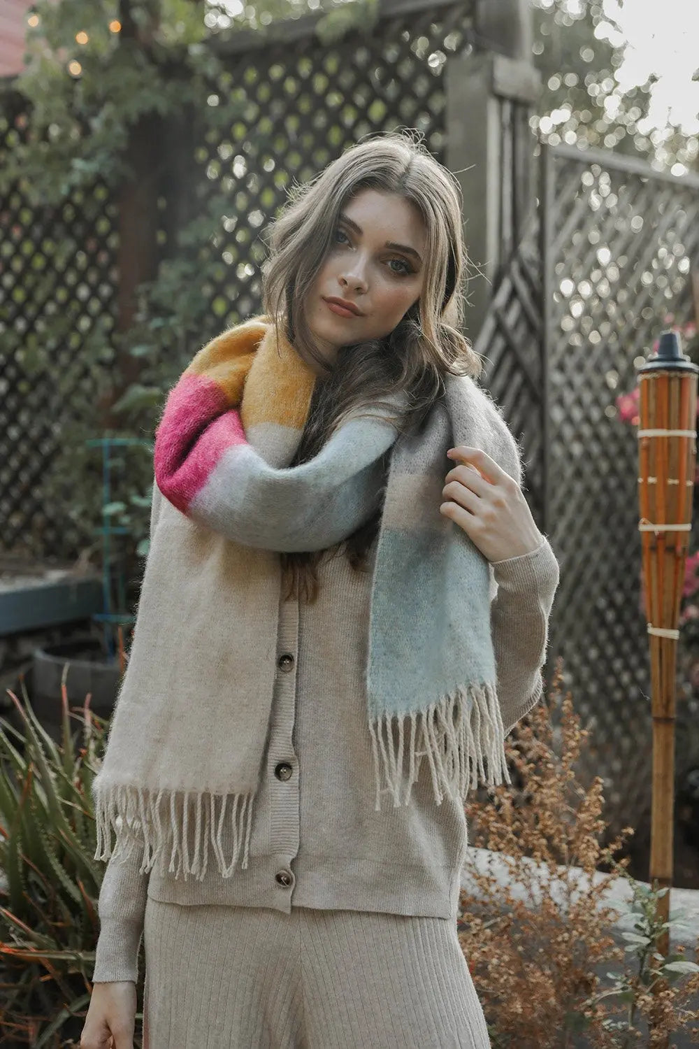 Striped mohair scarf with light gray base, rose accents, and long fringe ends.