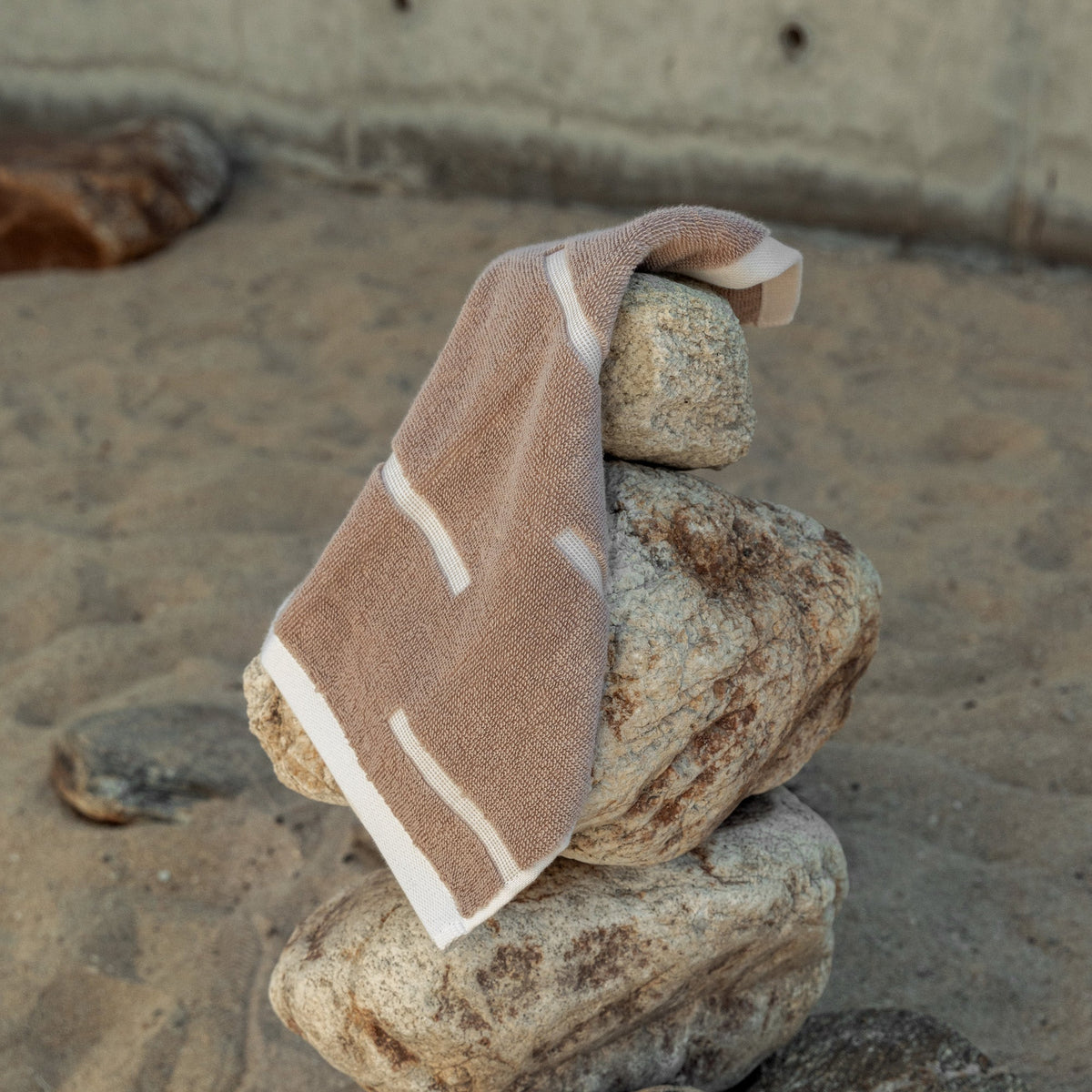 Sorrel Australian cotton towel in tan with ecru stripe border, folded