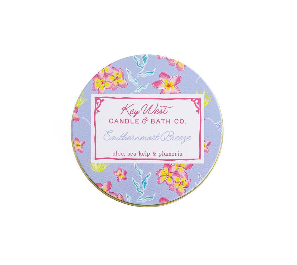 Round travel tin lid with Key West Candle & Bath Co. label and tropical blue florals