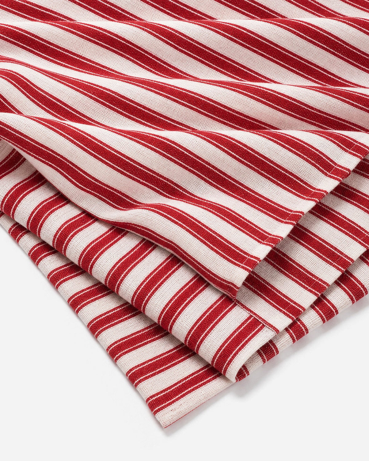 Stacked red and off-white striped tablecloth, neatly folded.