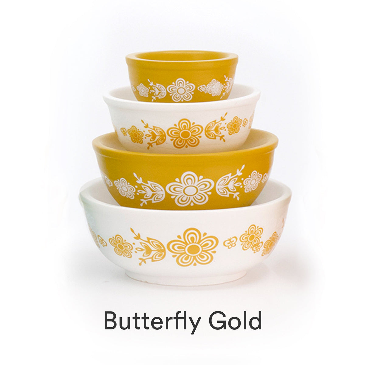 Mini stackable mixing bowl set with gold floral pattern on white and yellow bowls.
