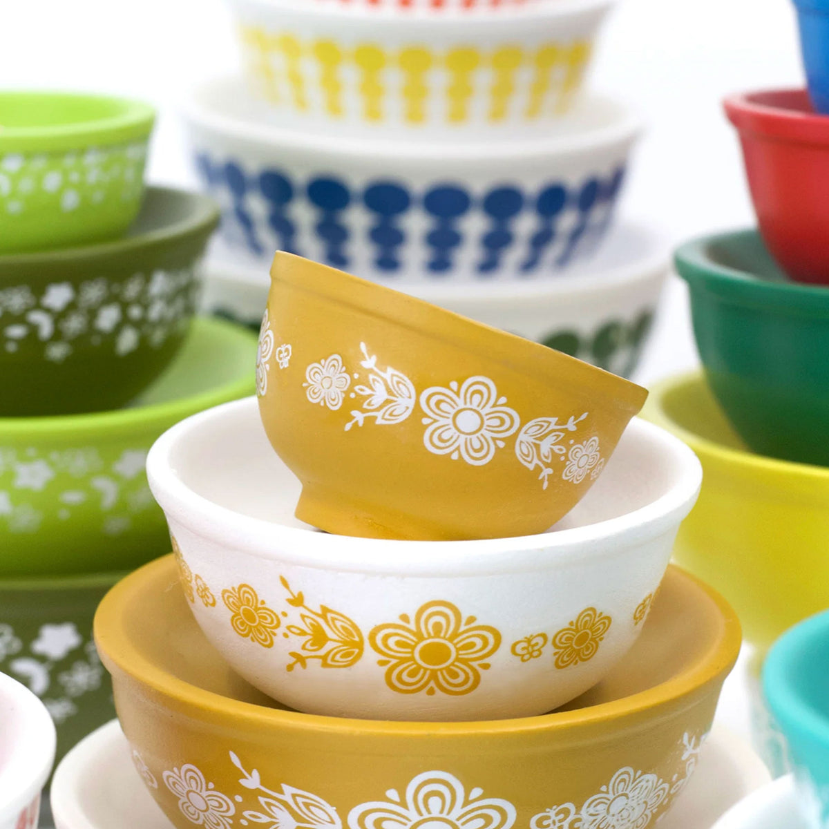 Stackable mini mixing bowls set with yellow, white, green, and blue retro floral prints