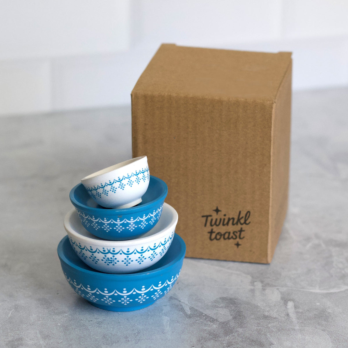 Stackable mini mixing bowls in blue and white with border pattern, with Twinkle Toast box