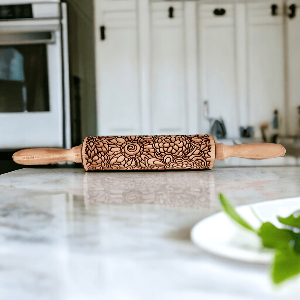 Embossed wood rolling pin with dark floral pattern and light wood handles