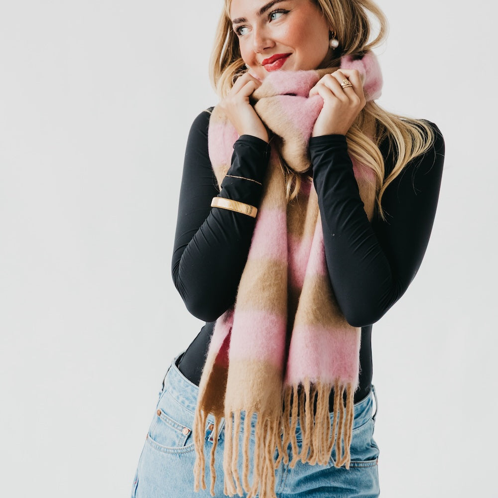 Pink and tan striped scarf with fringe trim and soft fuzzy texture
