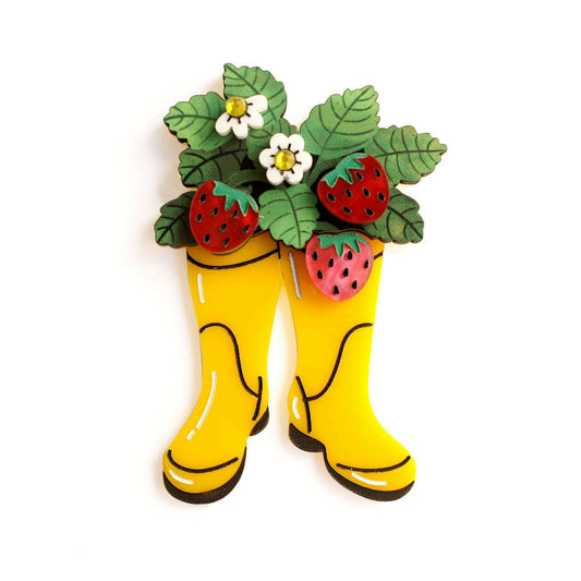 Yellow boot-shaped strawberry brooch with red berry accents and green leaves