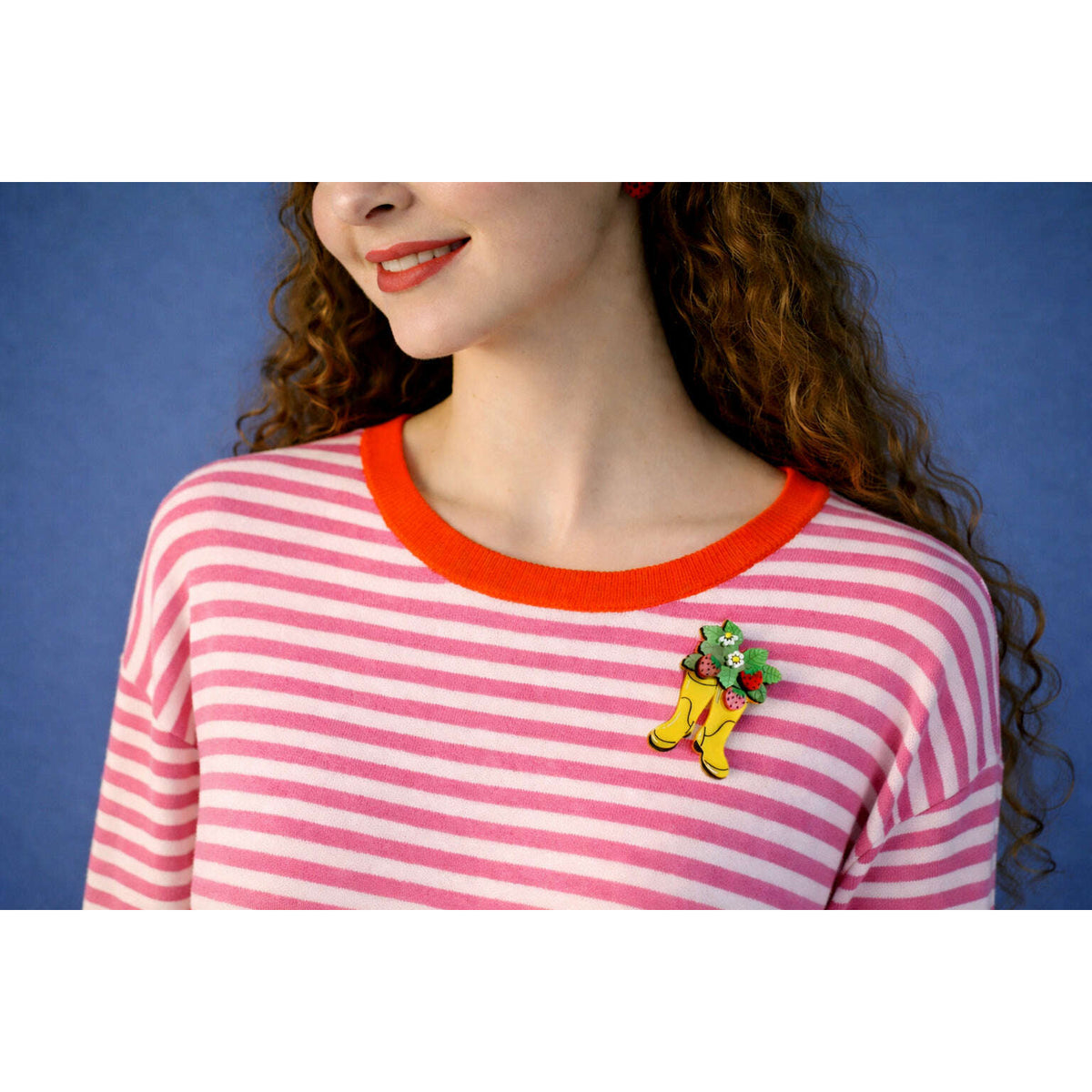 Pink-and-white striped shirt with yellow boot strawberry brooch featuring strawberries and flowers