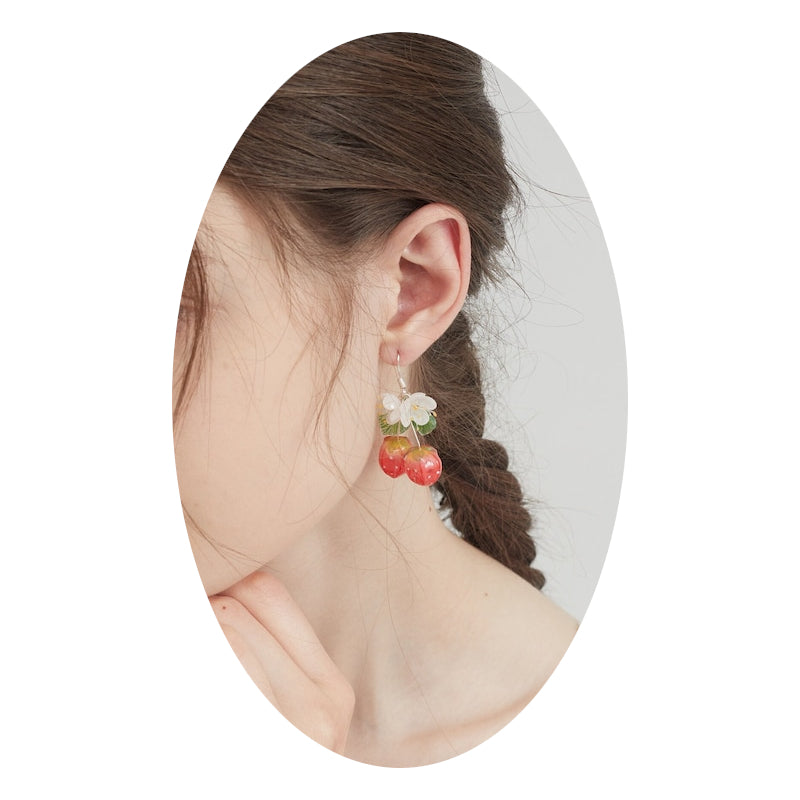 Strawberry and flower drop earrings worn, featuring white blossoms, green leaves, red berries
