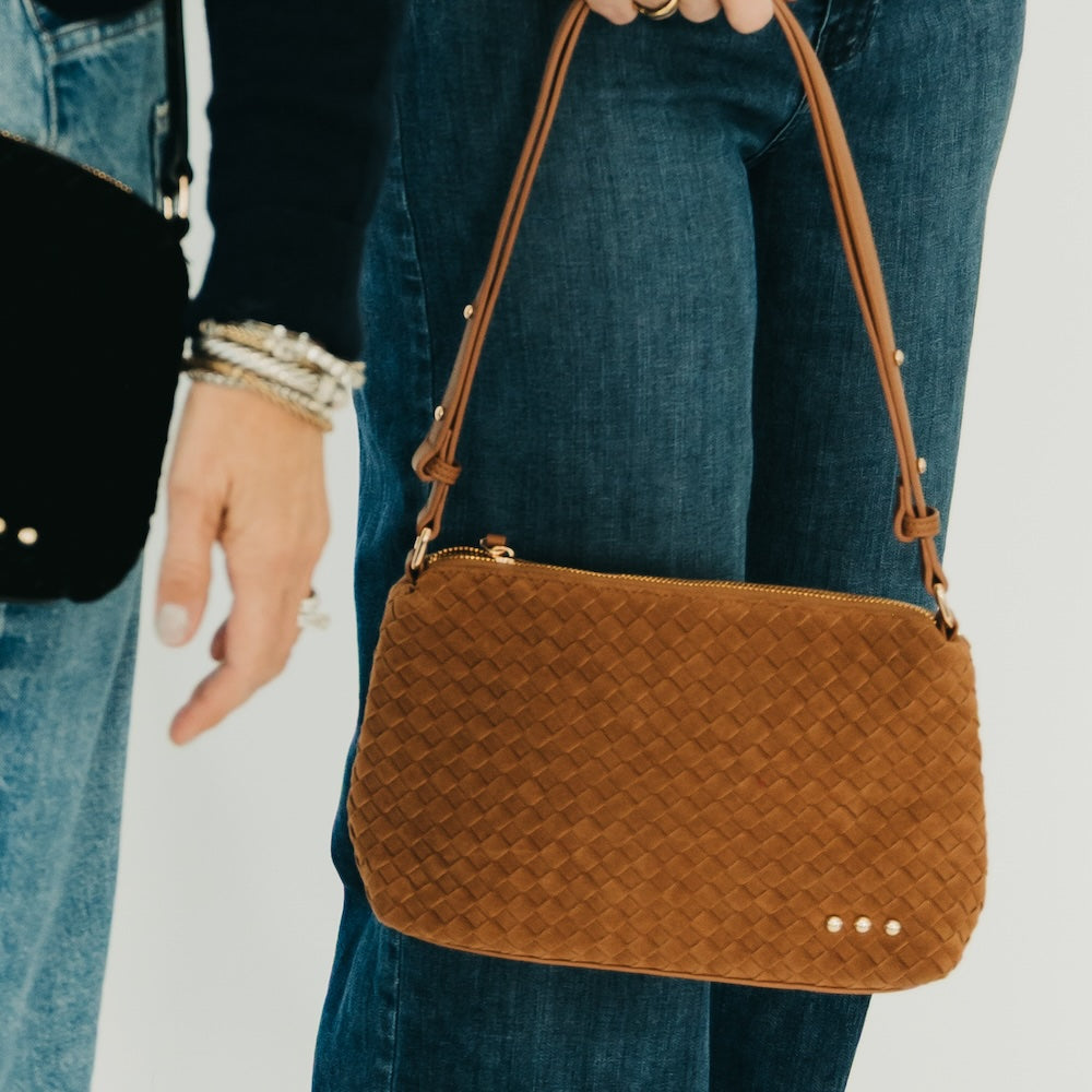 Brown woven suede hobo shoulder bag with braided pattern, top zipper and studs