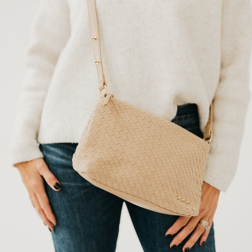 Light beige woven suede hobo shoulder bag with braided strap and gold snap accents