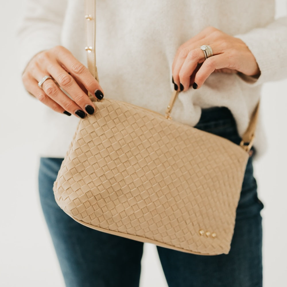 Light beige woven suede hobo shoulder bag close-up with gold snap detailing