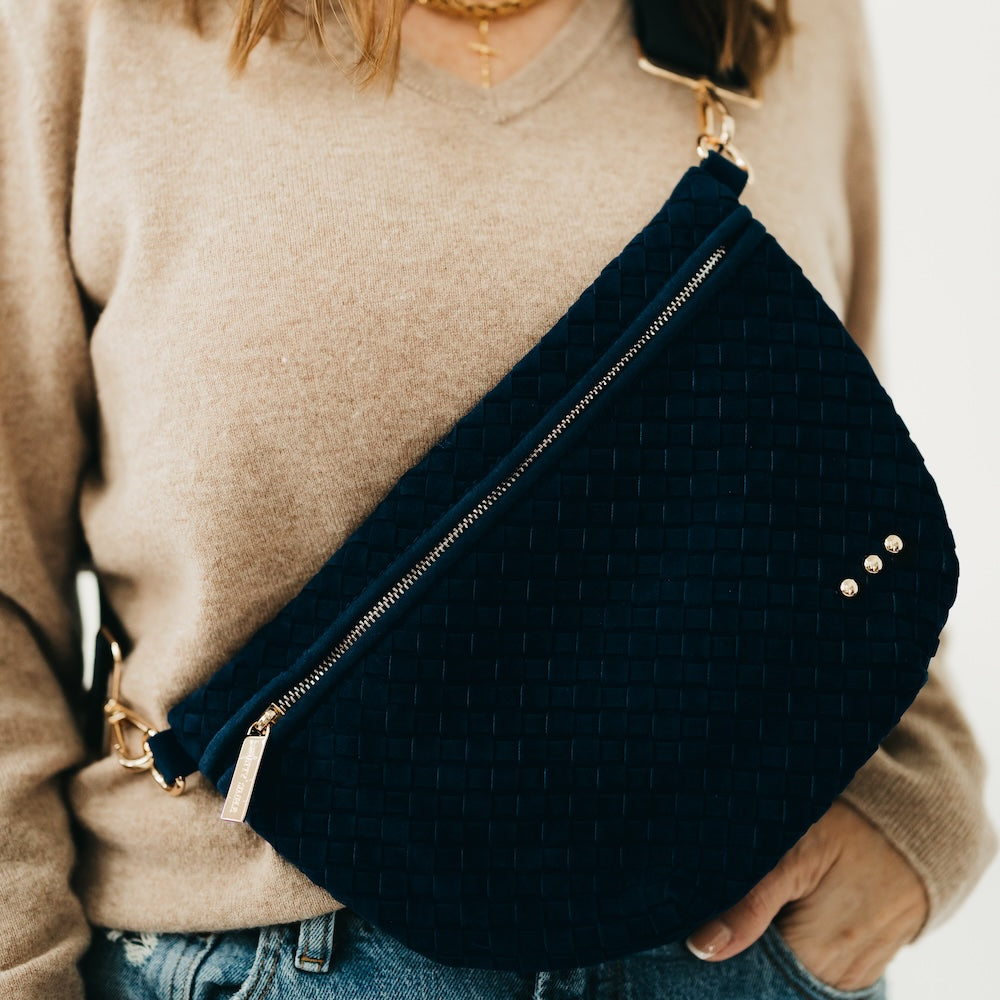 Navy woven suede bum bag with gold zipper, gold studs, and adjustable strap