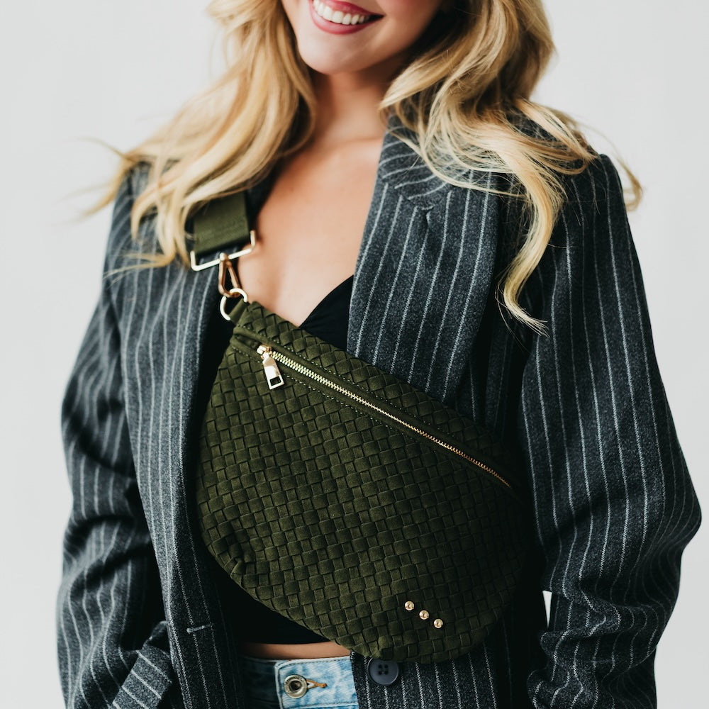 Olive green woven suede bum bag with top zipper, gold-tone hardware, and studs