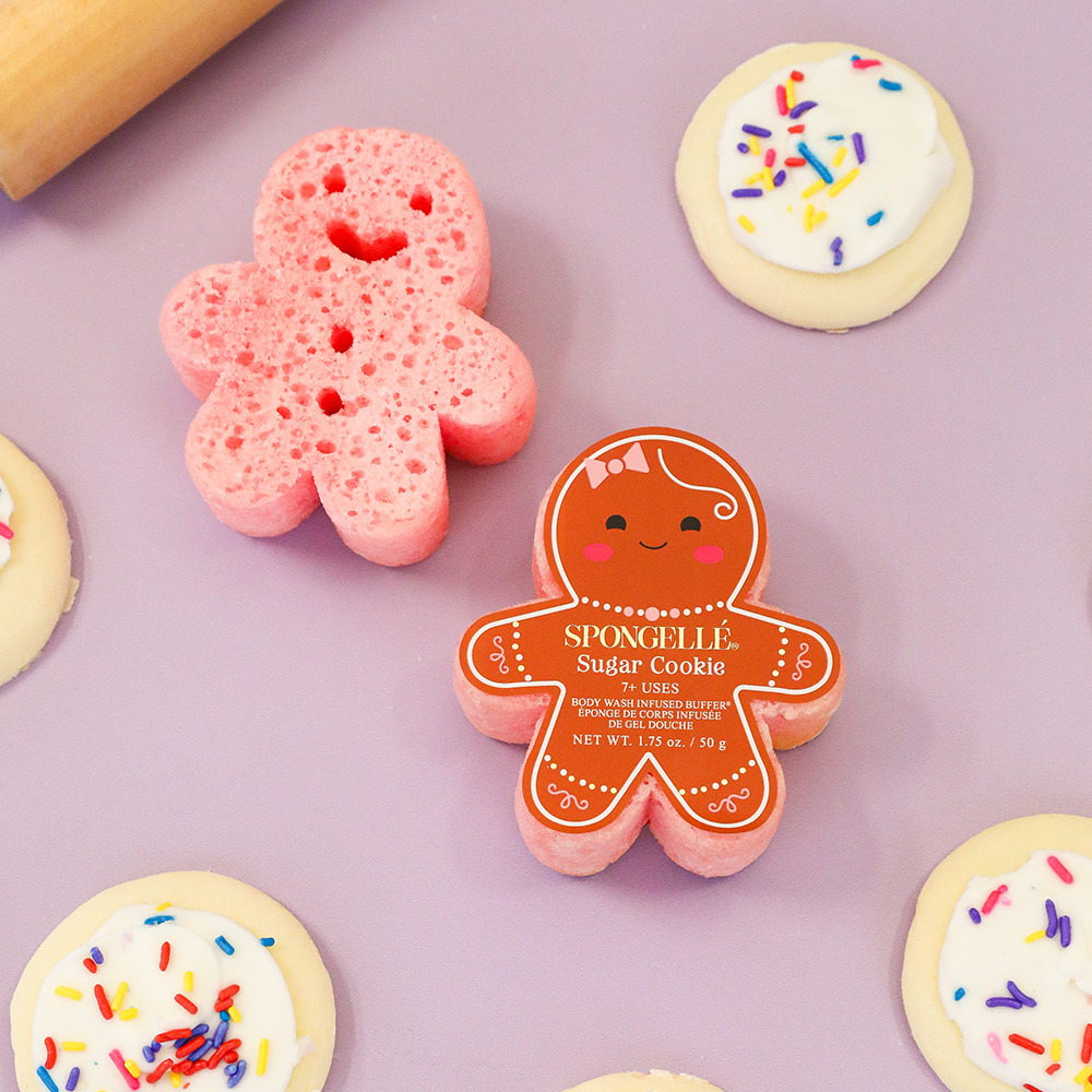 Pink gingerbread sugar cookie body buffers with white icing and colorful sprinkles