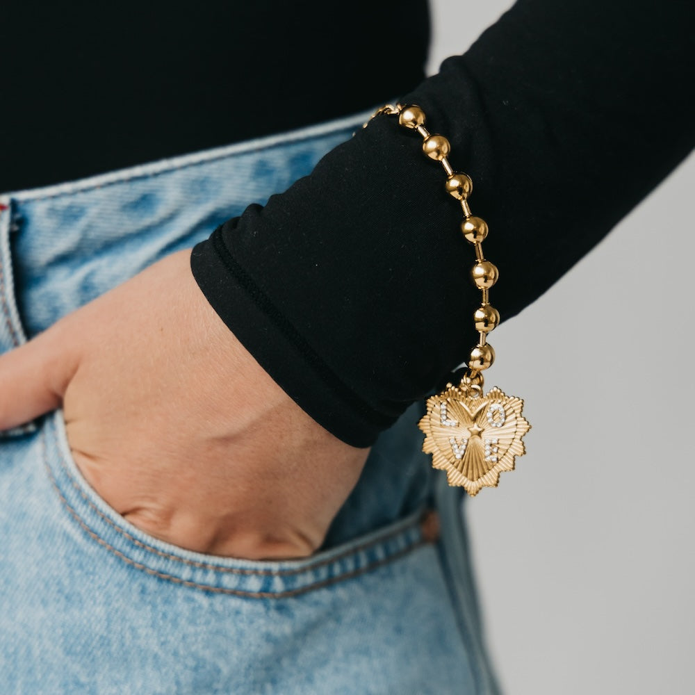 Gold-tone beaded bracelet with heart sunburst charm on chain