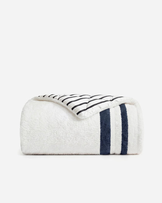 Striped comforter with off-white plush cover and dark navy vertical bands