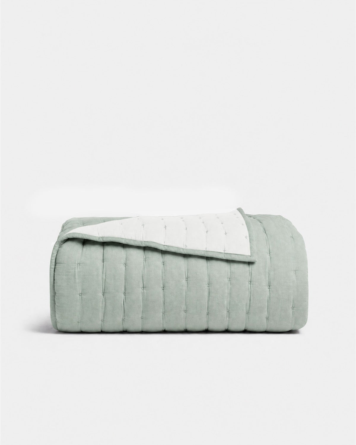 Blue cotton quilt with stitched channels and folded edge, quilted bedding cover