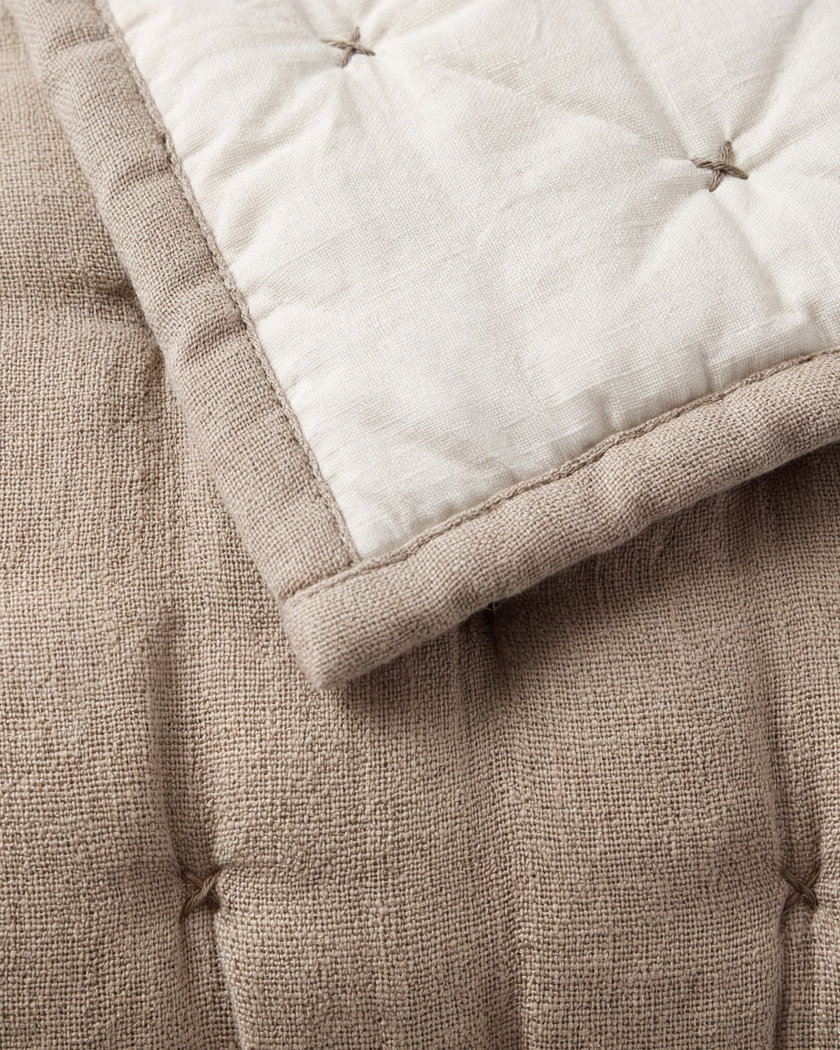 Taupe quilt corner close-up with stitched channels and pin-tuck knot details