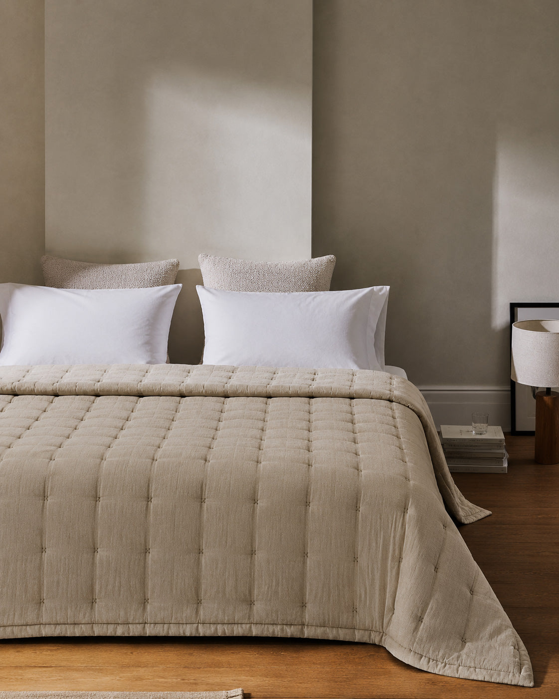 Taupe quilted bedspread with channel stitching and vertical tufted lines
