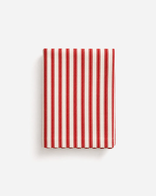 Red and off-white striped tablecloth, folded with vertical stripe pattern.