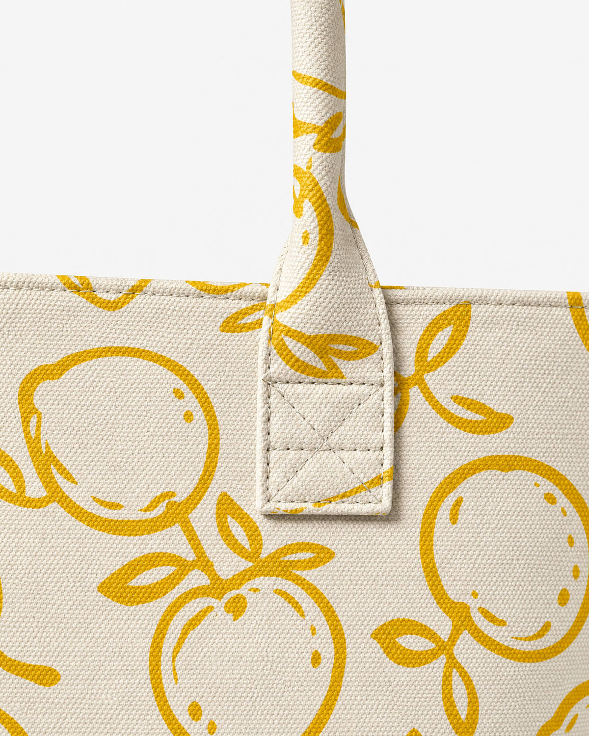 Close-up of ochre lemon print tote handle with reinforced stitching