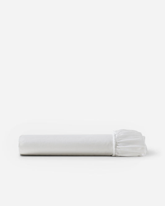 Luce white cotton sateen fitted sheet, folded with elastic edge