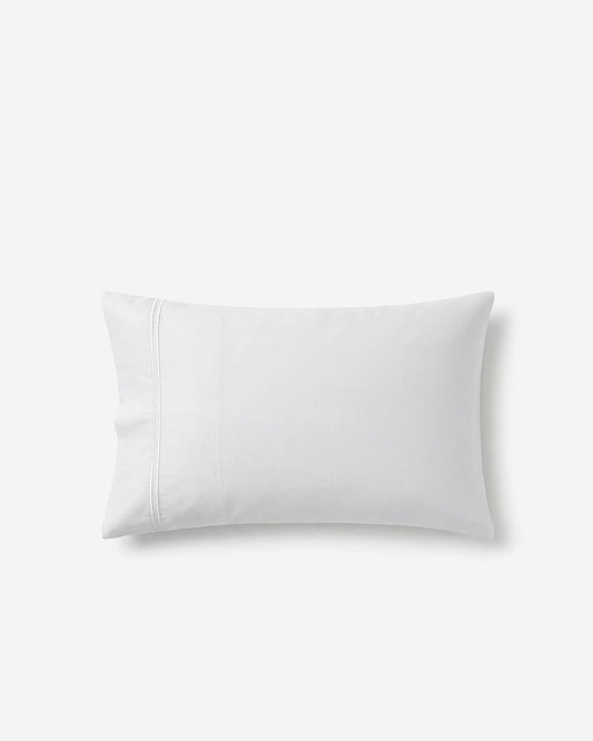 White cotton sateen pillowcase with neat piped seams and corner edge