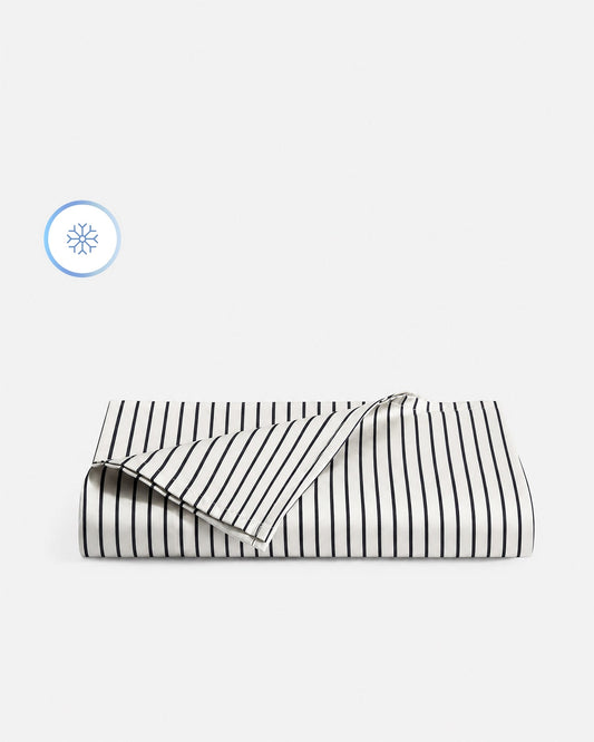 Striped white and dark blue cooling top sheet, folded view with overlapping corner