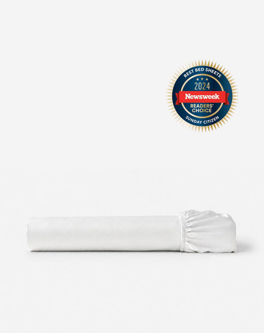 Bamboo viscose fitted sheet, white color, folded with gathered elastic edge.