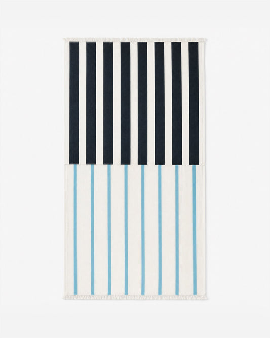 Folded beach blanket with dark navy and light-blue vertical stripe bands