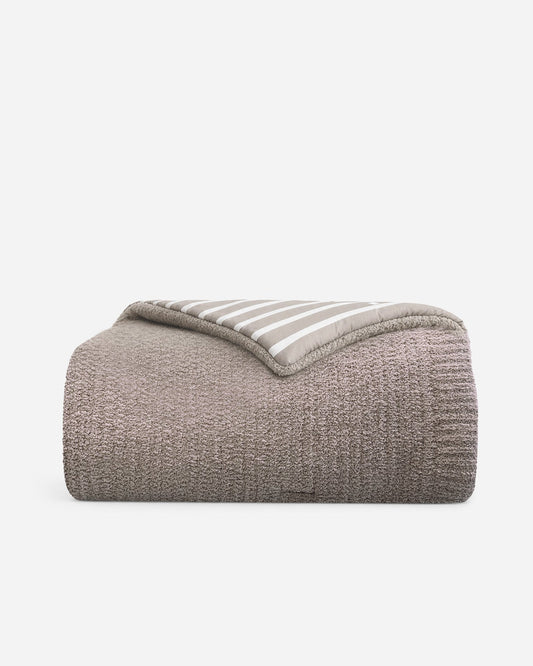 Taupe and off-white striped comforter with rolled edge, cozy textured fabric.