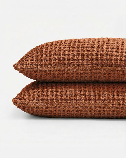 Set of two waffle-weave pillow shams in cinnamon brown with textured grid pattern