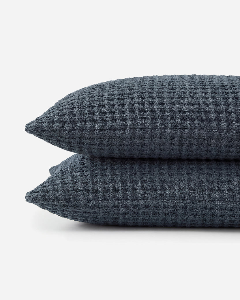 Midnight blue waffle shams stacked, showing textured weave