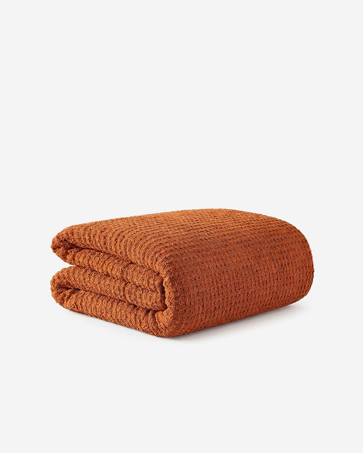 Cinnamon orange waffle comforter, folded with textured waffle weave