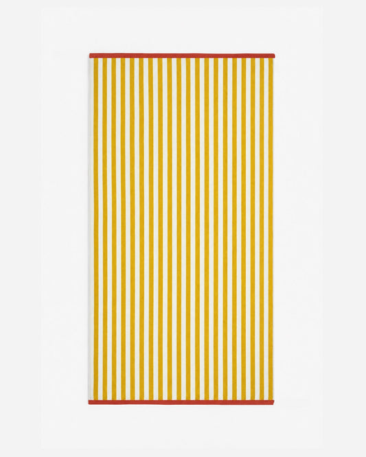 Reversible beach towel, ochre and white vertical stripes with red edging
