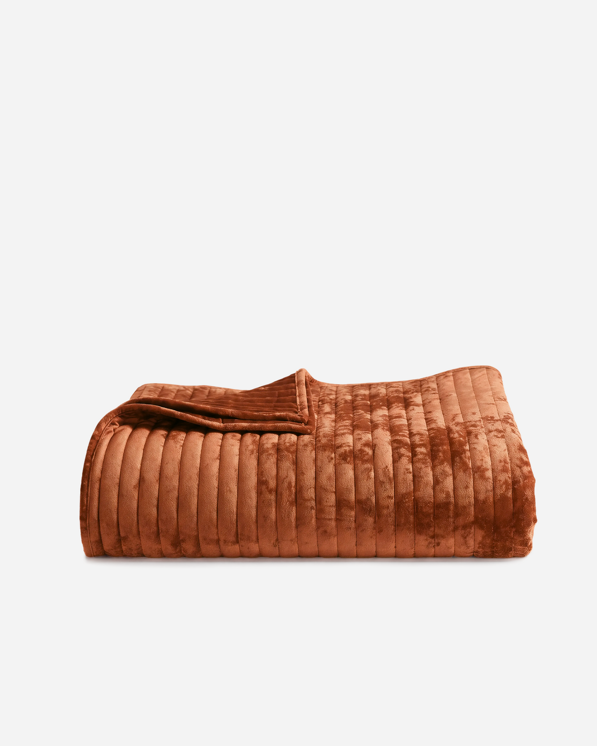 Rust velvet channel quilt, neatly folded with raised vertical ribs
