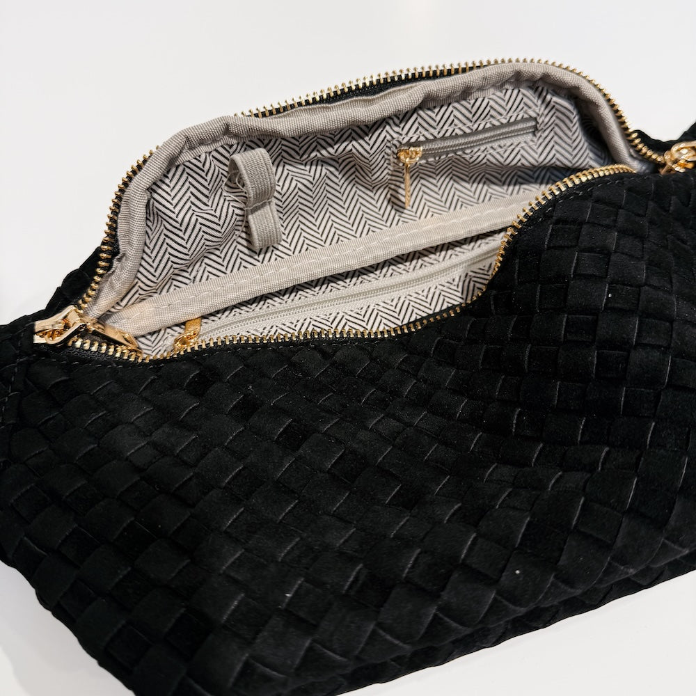 Woven suede bum bag in black with open top showing striped interior lining.