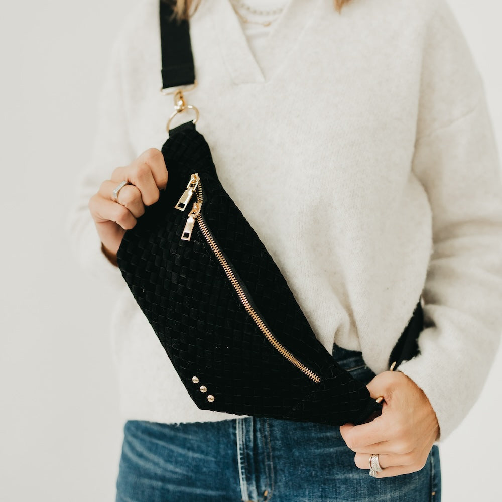 Woven suede bum bag in black with zip front, metal zipper pulls, and strap.