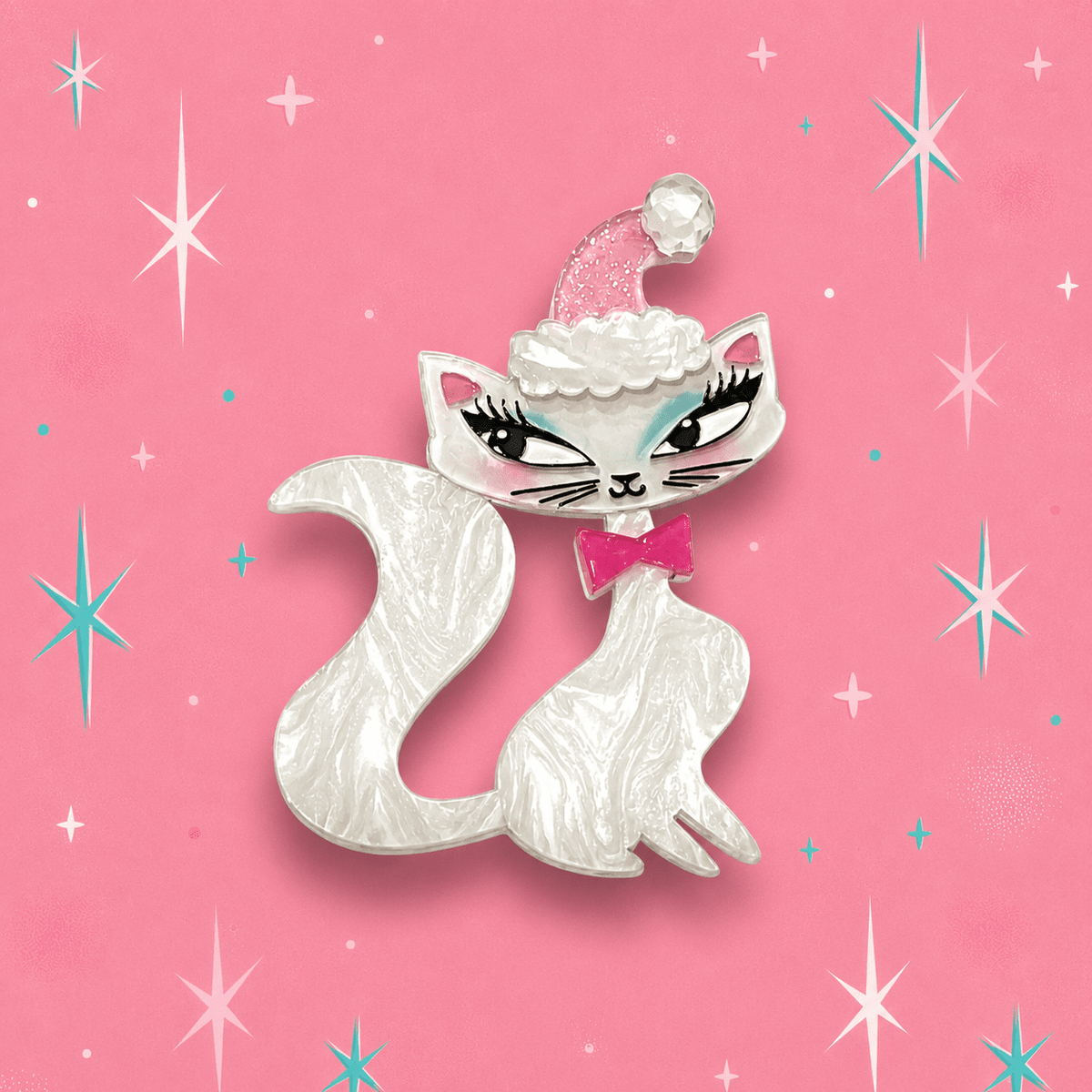 White cat brooch with pink cap, cloud trim, and pink bow with teal eyes
