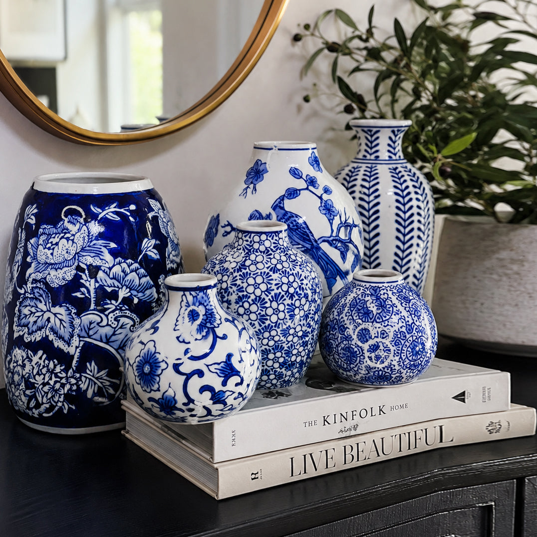 Set of blue-and-white patterned ceramic vases grouped on a tabletop