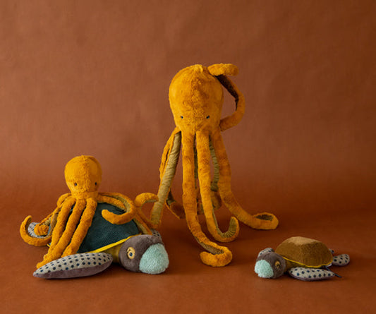 Large golden plush octopus with long tentacles, shown with smaller plush toys