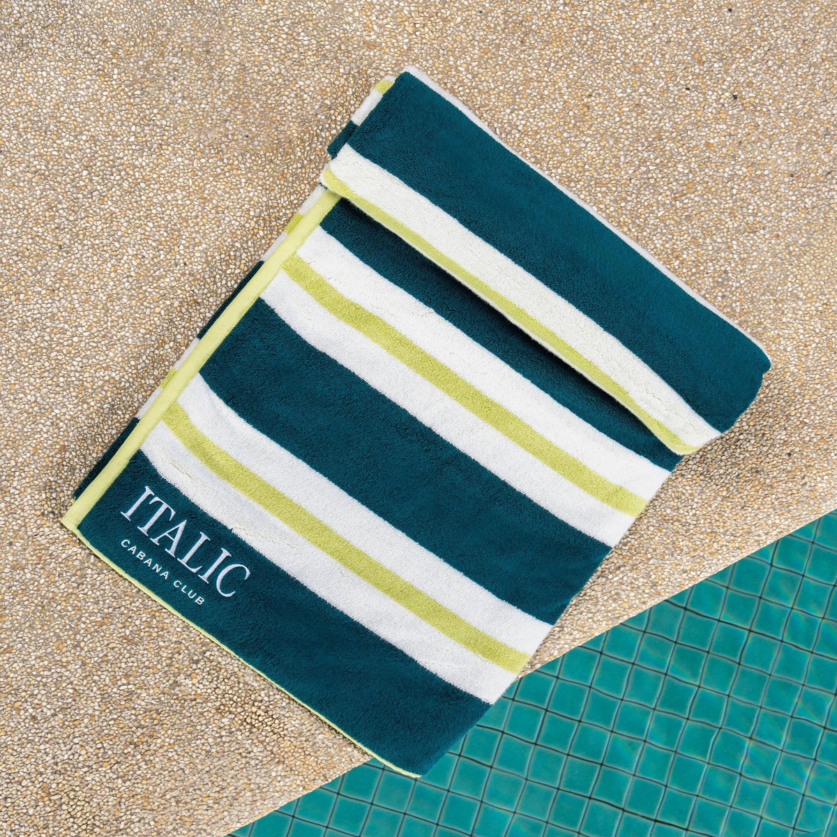 Cotton beach towel in teal and navy with light green and white stripe bands