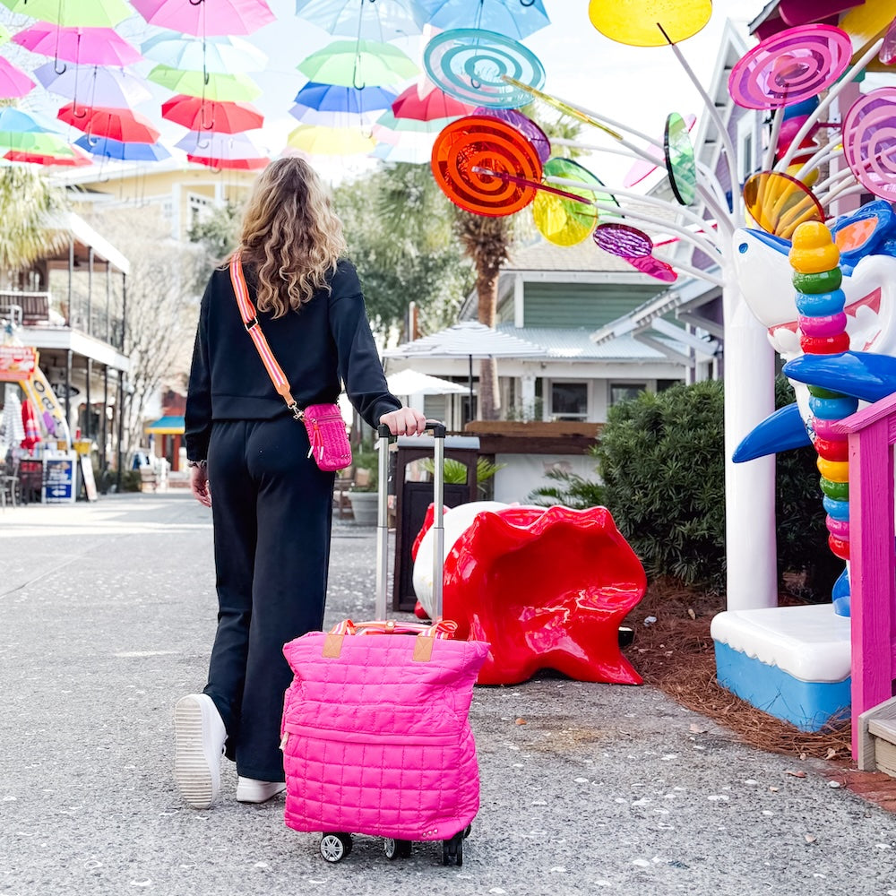 Pink quilted tote roller bag on wheels with telescoping handle