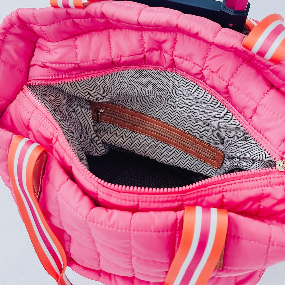 Pink quilted tote roller bag interior with gray lining and zip pocket